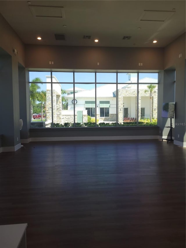 interior space featuring plenty of natural light and dark hardwood / wood-style flooring