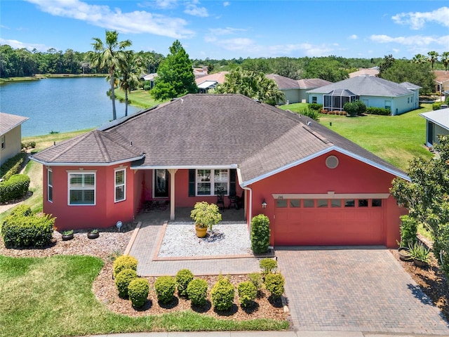 single story home with a water view, a garage, and a front yard