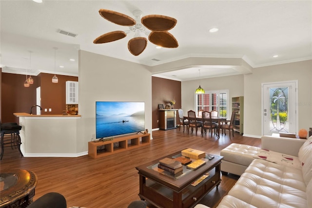 living room featuring dark hardwood / wood-style floors and ornamental molding