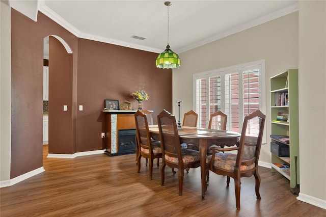 dining space featuring crown molding and hardwood / wood-style flooring