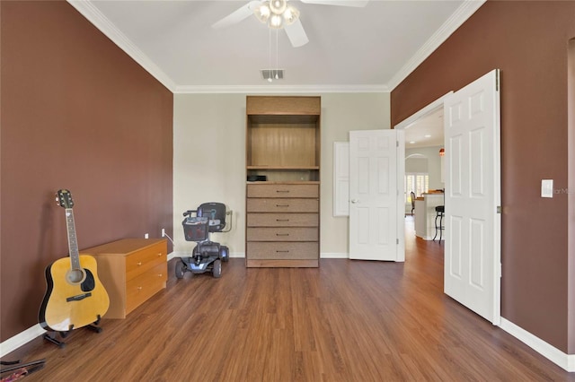 miscellaneous room with ornamental molding, ceiling fan, and dark hardwood / wood-style flooring