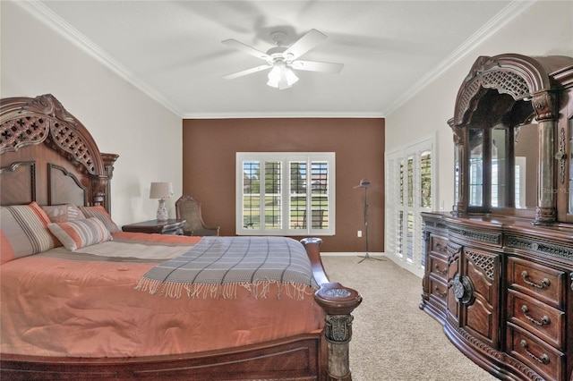 carpeted bedroom featuring ceiling fan and crown molding