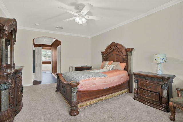 carpeted bedroom featuring crown molding and ceiling fan