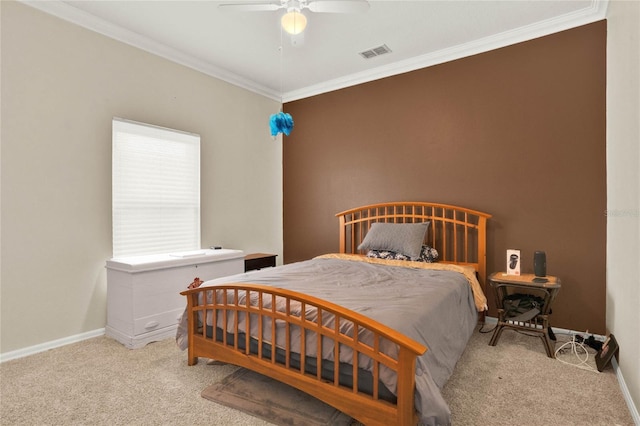 carpeted bedroom featuring ceiling fan and crown molding