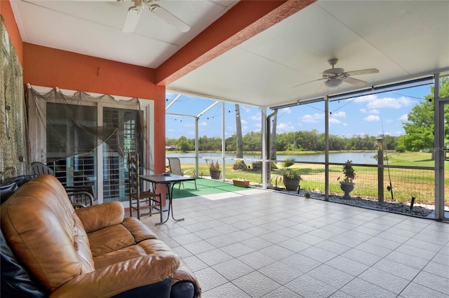 sunroom / solarium with a water view and ceiling fan