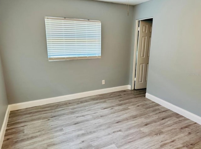 spare room with hardwood / wood-style flooring