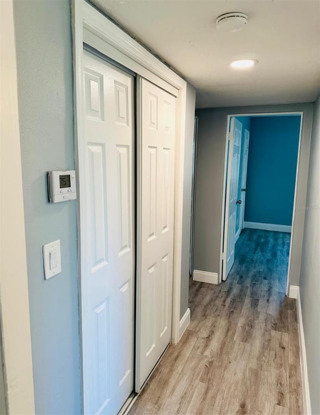 hall with light hardwood / wood-style flooring