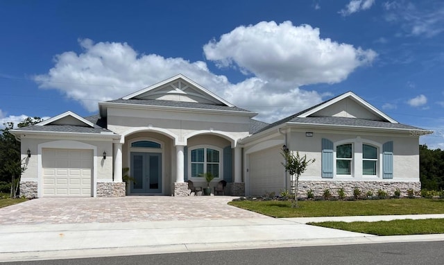 view of front of house featuring french doors, a garage, and a front yard