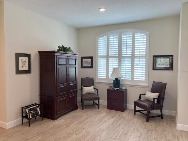 living area with light hardwood / wood-style flooring