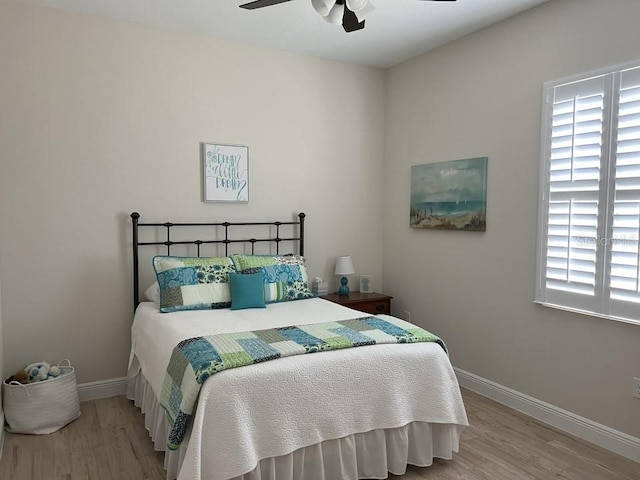 bedroom with hardwood / wood-style floors and ceiling fan