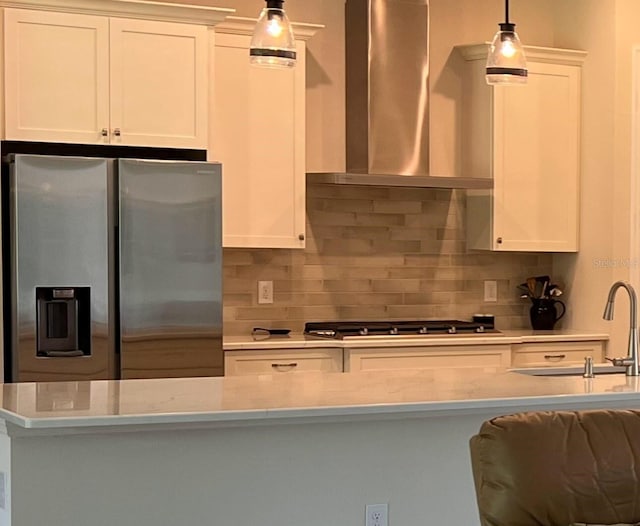 3962 Kennebunk Loop, Mount Dora, FL 32757 - kitchen featuring stainless steel appliances, wall chimney exhaust hood, decorative backsplash, light countertops, and hanging light fixtures