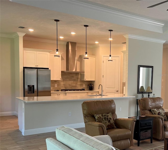 3962 Kennebunk Loop, Mount Dora, FL 32757 - kitchen with appliances with stainless steel finishes, wall chimney range hood, open floor plan, a sink, and light countertops