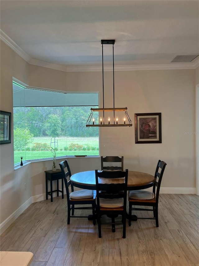 3962 Kennebunk Loop, Mount Dora, FL 32757 - dining room with wood finished floors, a chandelier, crown molding, and baseboards