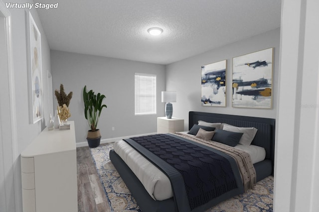 bedroom featuring wood-type flooring and a textured ceiling