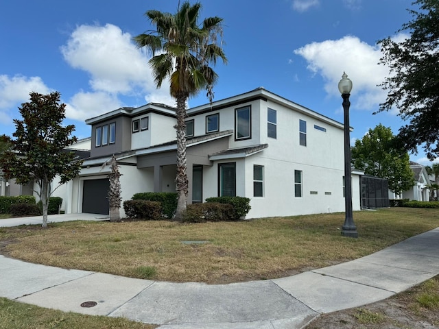 view of property with a garage and a front yard