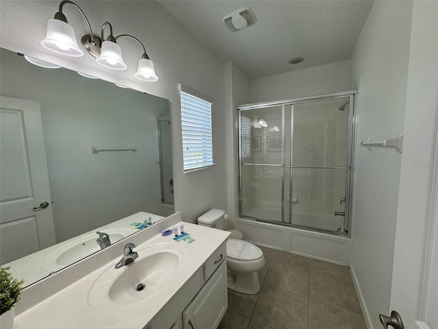 full bathroom with tile flooring, combined bath / shower with glass door, vanity, and toilet