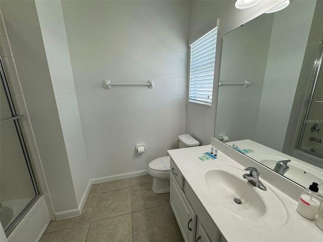 full bathroom featuring vanity with extensive cabinet space, toilet, bath / shower combo with glass door, and tile flooring