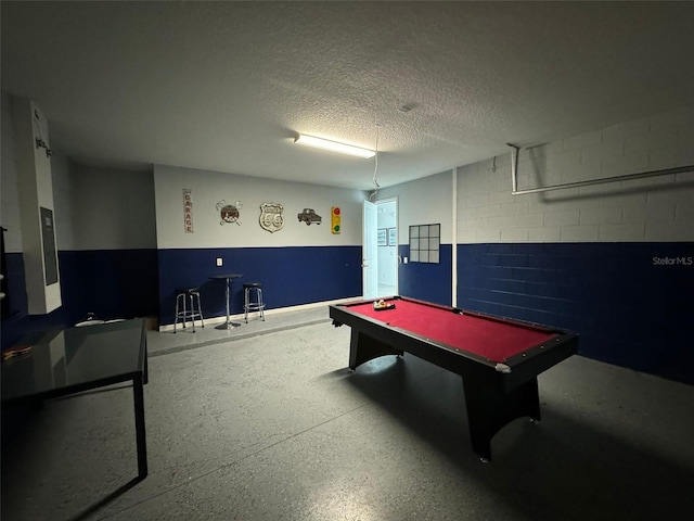 recreation room with a textured ceiling and billiards