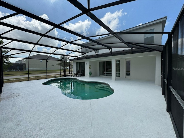 view of pool featuring a patio and glass enclosure