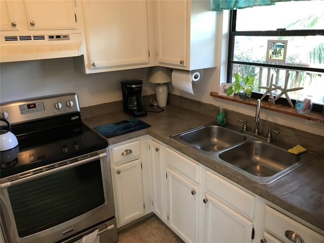 kitchen with white cabinets, sink, stainless steel range with electric stovetop, and tile floors