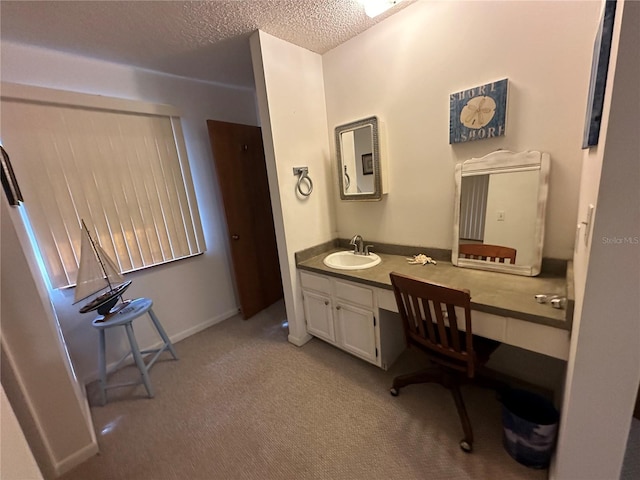 bathroom featuring a textured ceiling and vanity