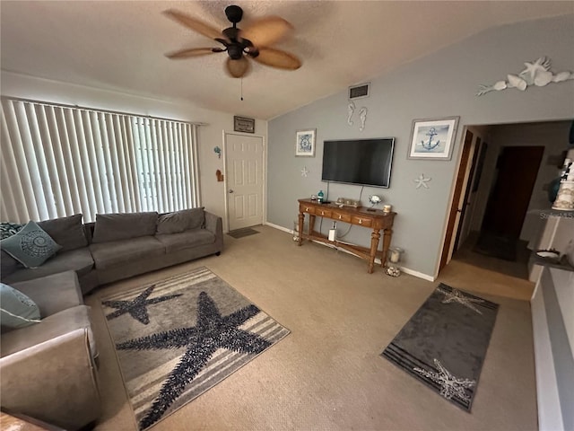 carpeted living area featuring ceiling fan, visible vents, vaulted ceiling, and baseboards