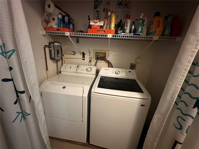 clothes washing area with washer and dryer and laundry area