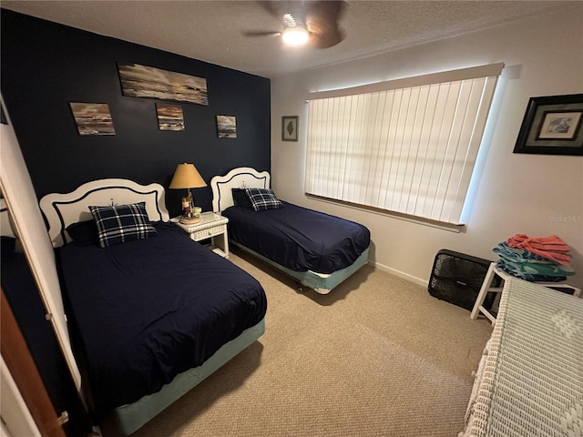 bedroom with baseboards, carpet, a ceiling fan, and a textured ceiling