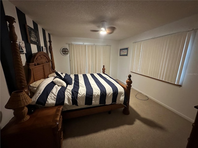 bedroom featuring carpet floors, baseboards, a ceiling fan, and a textured ceiling