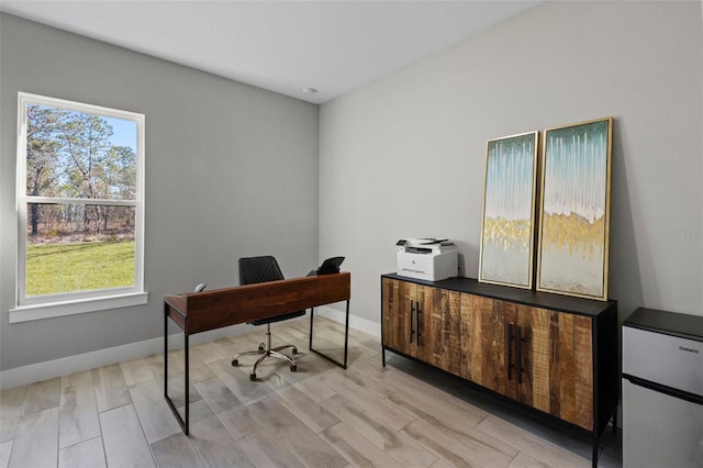 office space with light wood-type flooring and a wealth of natural light