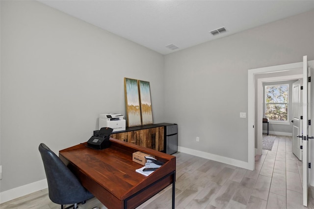 office space with light hardwood / wood-style flooring