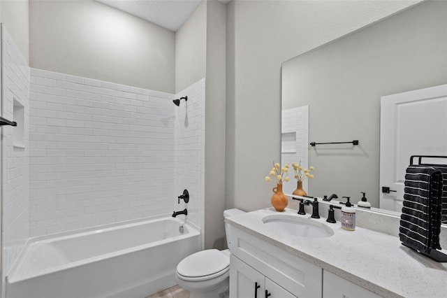 full bathroom featuring toilet, vanity, and tiled shower / bath combo