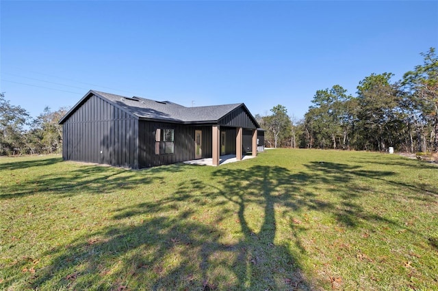 rear view of property with a yard