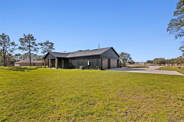 exterior space featuring a lawn and a garage