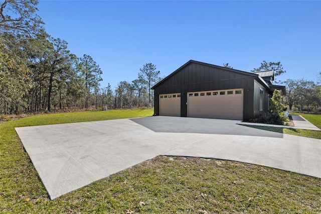 exterior space with a garage and a lawn