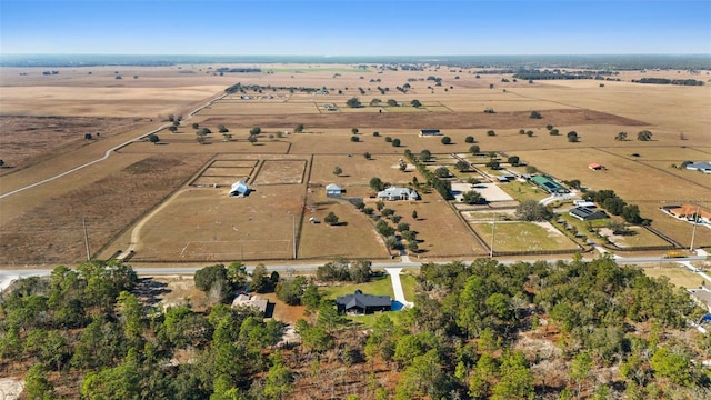 birds eye view of property with a rural view