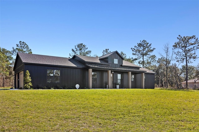 view of front of property with a garage and a front lawn