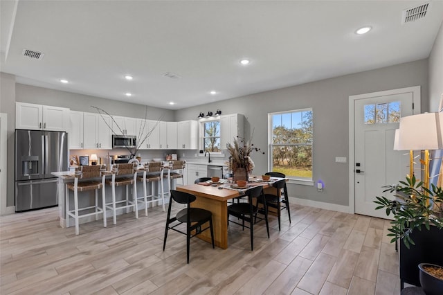 dining room featuring light wood-type flooring and sink