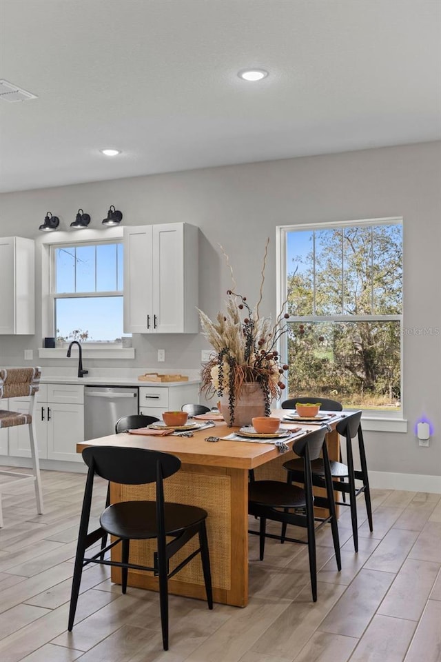 dining space with light hardwood / wood-style floors and sink