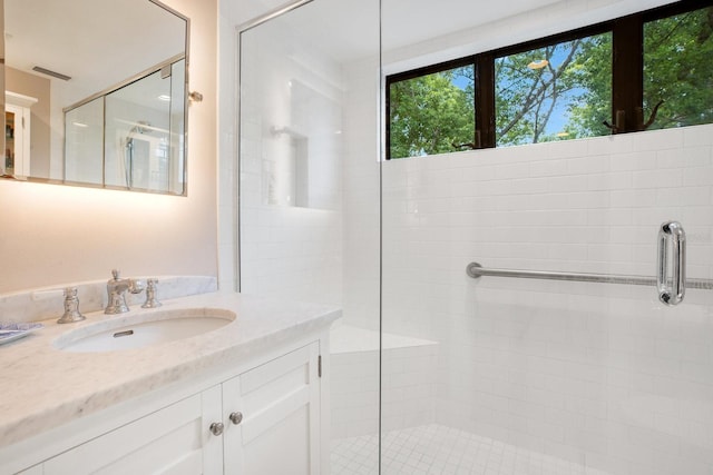 bathroom with vanity and a shower with shower door