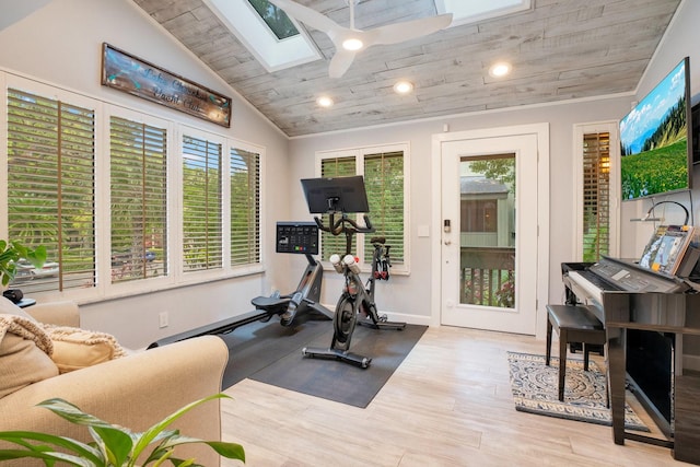 exercise room with light hardwood / wood-style flooring, wood ceiling, a wealth of natural light, and lofted ceiling with skylight