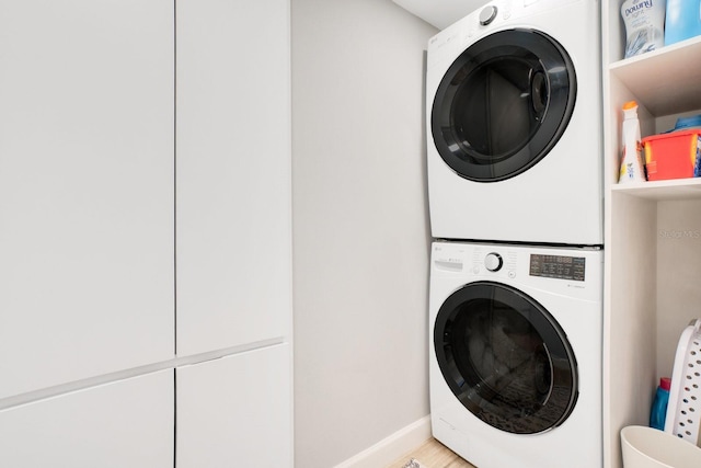 laundry area with stacked washer and clothes dryer