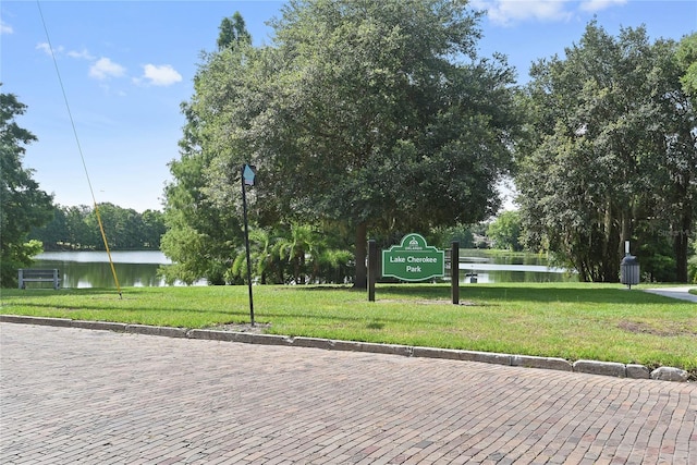 view of community featuring a water view and a yard