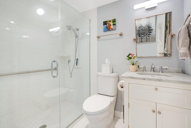 bathroom featuring vanity, toilet, and walk in shower