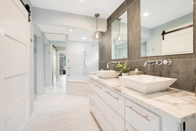 bathroom featuring tasteful backsplash, vanity, a shower, and tile walls