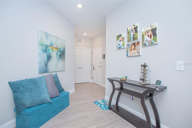 hallway with hardwood / wood-style floors