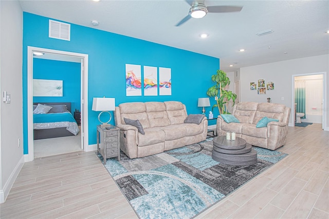 living room with ceiling fan and carpet floors