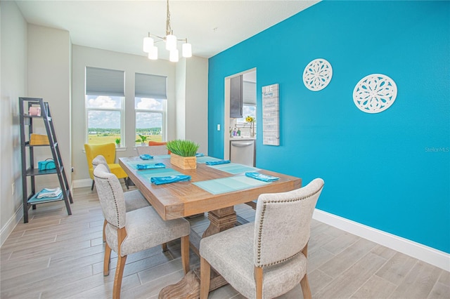 dining space with hardwood / wood-style floors and a notable chandelier