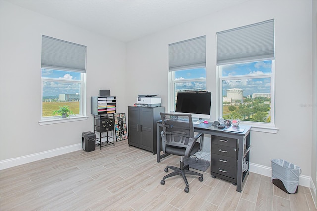 office area with light hardwood / wood-style floors