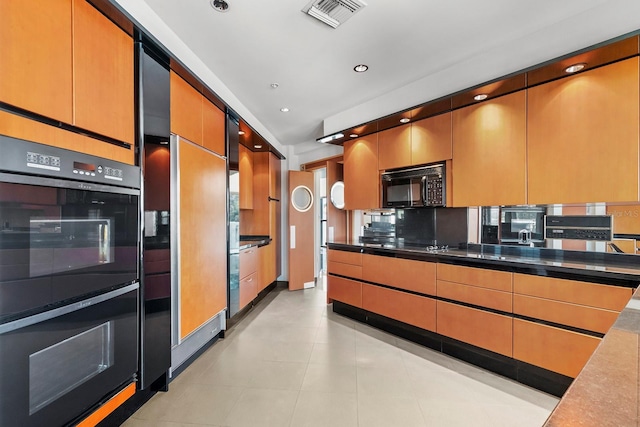 kitchen with tasteful backsplash and black appliances